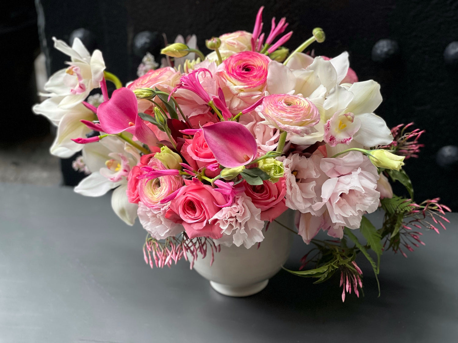 these flowers, so white and pink, are like stars that in the Earth’s firmament do shine. the whiteness of ranunculus and calla lilies make the arrangement pop out. The violet of the orchids works as an accent color giving a sense of harmony and beauty. 