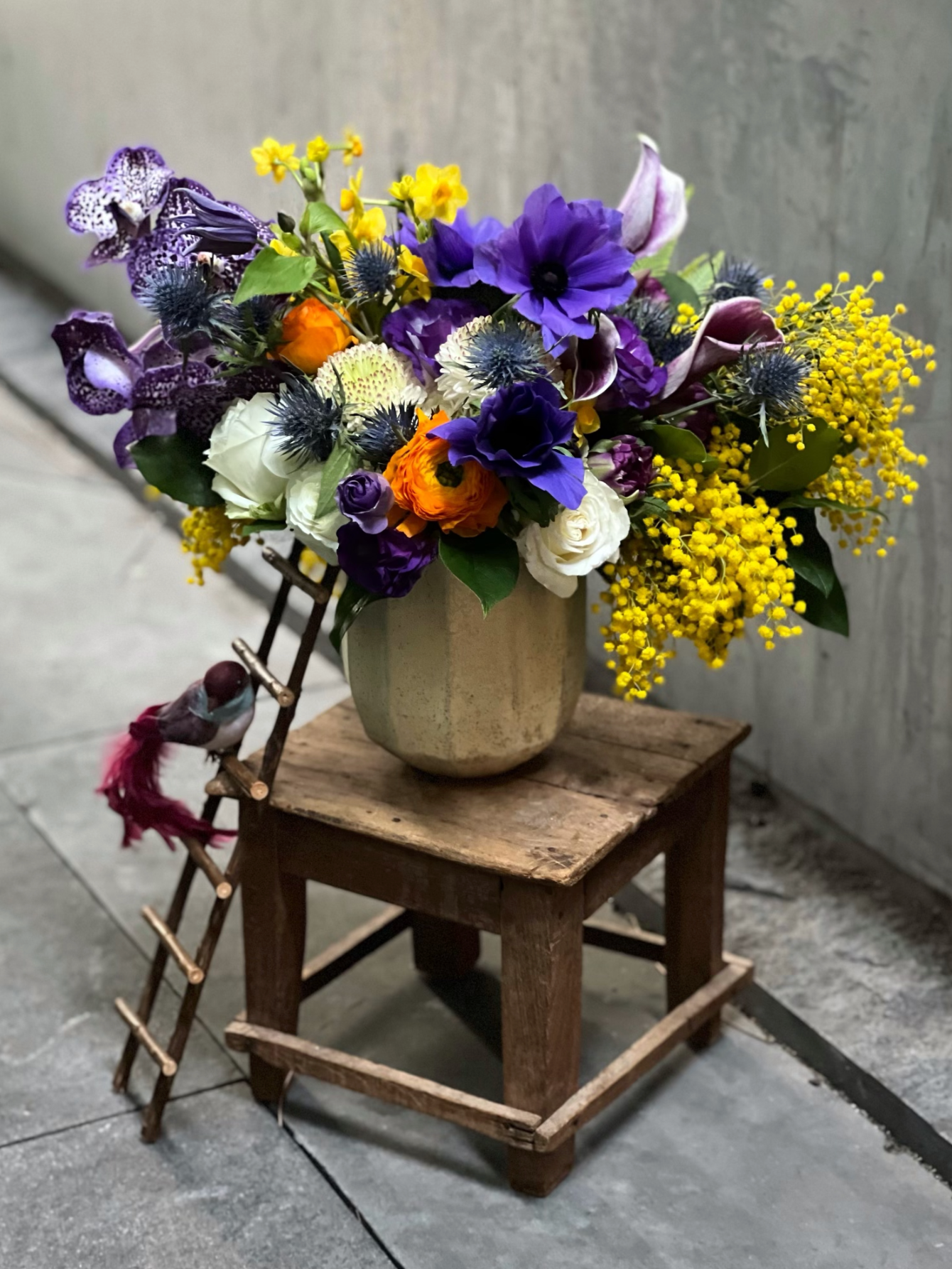 violet poppy anemones, daffodils and orchids make an impressive focal point.