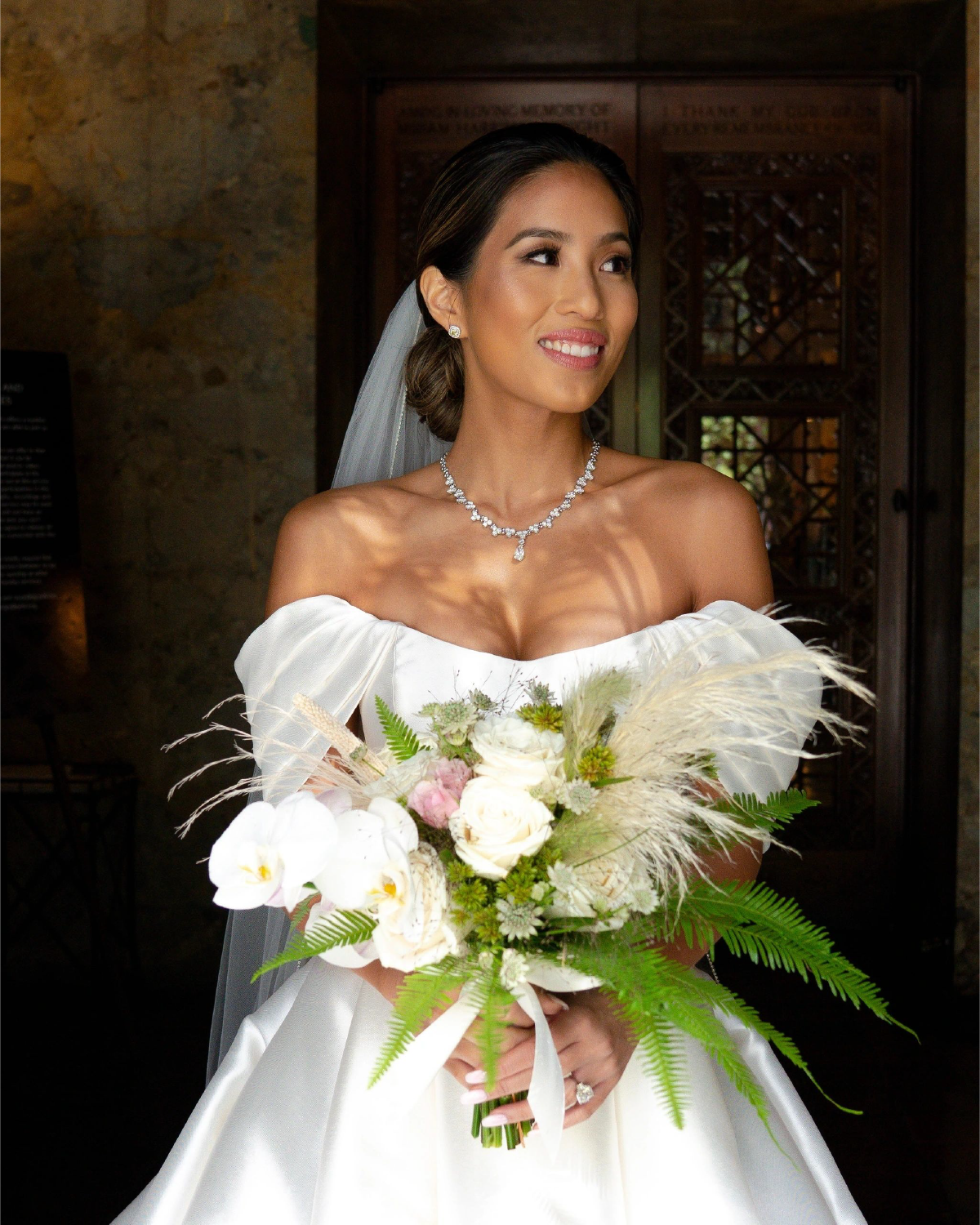 bride in a white wedding  dress holding bouquet